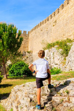 Photo for Children looking at Obidos fortress, near Lisbon in Portugal- Family vacation, travel, tourism - Royalty Free Image