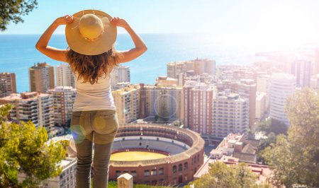 Photo for Woman looking at panoramic view of Malaga city in Spain - Royalty Free Image