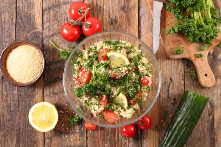 Photo for Tabbouleh salad on wood background - Royalty Free Image
