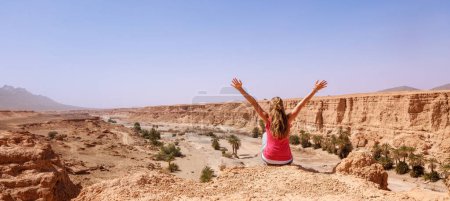Téléchargez les photos : Femme avec les bras levés, falaise et canyon- Maroc - en image libre de droit