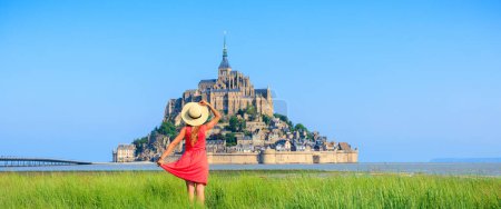Foto de Mujer con vestido rojo en Normandia- famoso Mont Saint Michel en Francia - Imagen libre de derechos
