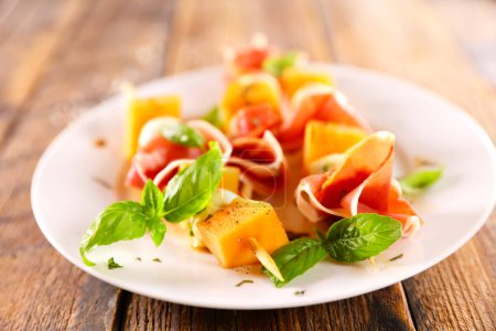 Photo for Prosciutto and ham with fresh basil - Royalty Free Image