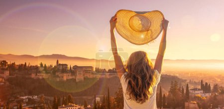 Photo for Woman enjoying panoramic view of Granada city landscape at sunset - Royalty Free Image