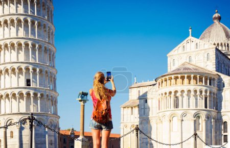 Foto de Mujer viajando por Italia y tomando fotografías con el teléfono inteligente torre de Pisa, Catedral- turismo, viajes en Europa - Imagen libre de derechos