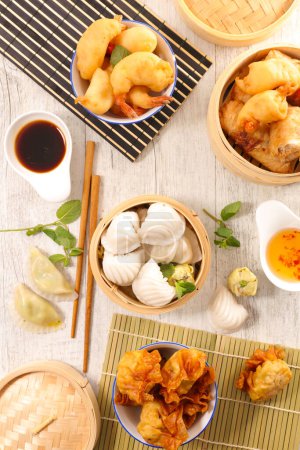 Photo for Assorted of asian food- dumpling, fried shrimp, spring roll and spicey sauce - Royalty Free Image