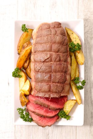 Photo for Roast beef sliced with fried potatoes - Royalty Free Image