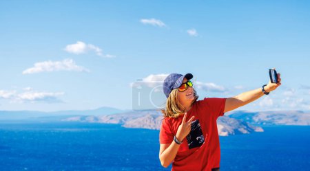 Photo for Teenager taking selfie in summer vacation- Croatia, adriatic sea and islands - Royalty Free Image