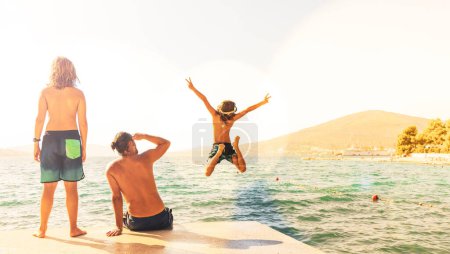 Photo for Happy family having fun in holiday- children jumping into water- travel,vacation,summer destination - Royalty Free Image