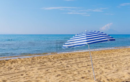 Foto de Hermosa playa y azul umbrella- concepto de fondo de playa - Imagen libre de derechos
