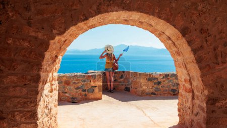 Photo for Traveler woman with Greek flag looking at the sea- Travel, tour tourism, vacation concept - Royalty Free Image