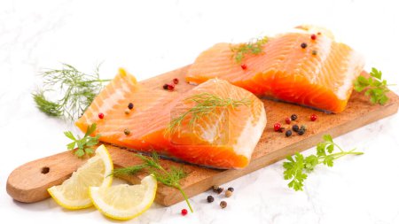 Photo for Raw salmon fillet with lemon and peppers - Royalty Free Image