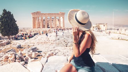 Photo for Young female tourist looking at the Parthenon, Acropolis in Athens- travel, tour tourism in Greece - Royalty Free Image