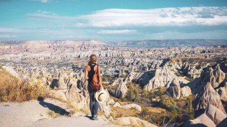Photo for Back view of young woman enjoying rock formation in Cappadocia- Travel, tour tourism, travel destination in Turkey - Royalty Free Image