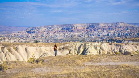 Photo for Woman tourist standing and contempling panoramic landscape view of Cappadocia in Turkey - Royalty Free Image