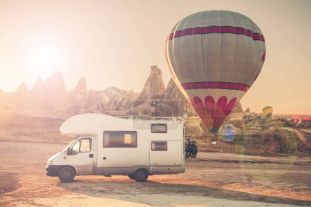 Photo for Motorhome in Cappadocia with flying hot air balloon- Travel, vacation, adventure in Turkey - Royalty Free Image