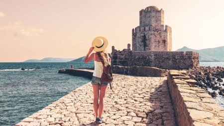Photo for Traveller woman enjoys summer vacation in Greece, Peloponnese,Messenia, Bourtzi tower - Royalty Free Image