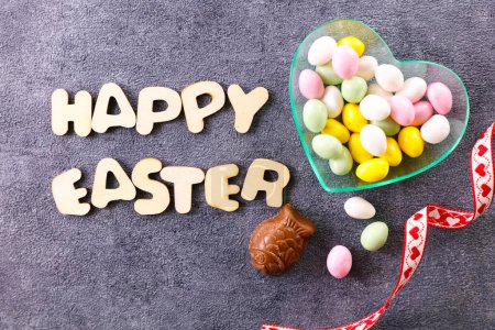 Photo for Happy easter card messaging with candies - Royalty Free Image