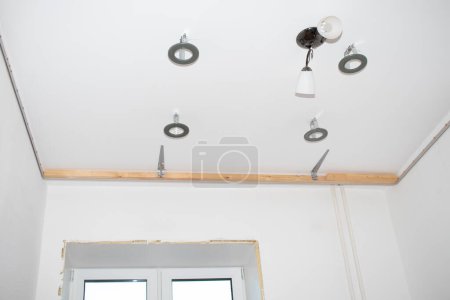 Photo for Installation of LED lamps on a stretch ceiling. - Royalty Free Image