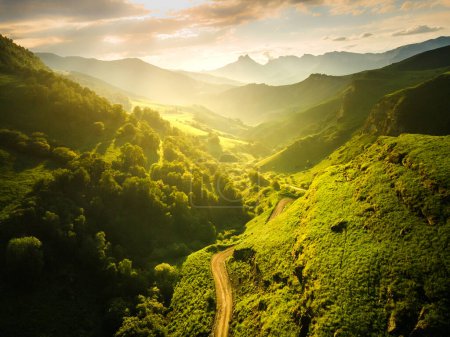 View of the green mountains and hills at sunset. Beautiful summer landscape. Aktoprak Pass in North Caucasus, Russia.