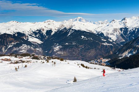 Photo for Ski resort in winter Alps mountains, France. Skiers ride on the ski slope. Courchevel, France. Winter landscape - Royalty Free Image