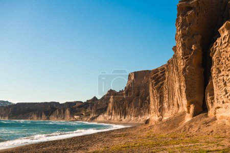 Photo for Volcanic cliffs on Vlichada beach, Santorini island, Greece. View of the sea coast at sunny day. Famous travel destination - Royalty Free Image