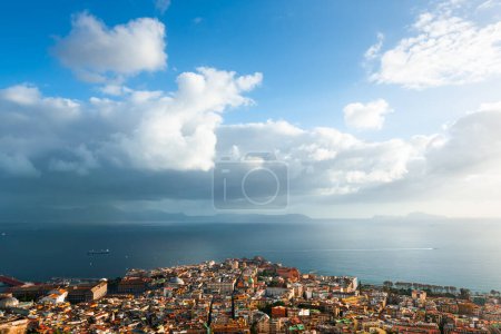 Panoramic view of Naples city and Gulf of Naples, Italy. Blue sea and the sky with clouds at sunset. Famous travel destination. 