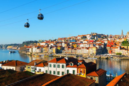 Porto, Portugal. Panoramic view of the old town and Douro river. Tourist cable car over the promenade. Famous travel destination