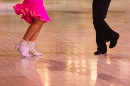 Photo for Attractive young couple of children dancing ballroom dance. Girl and boy dancer latino international dancing. - Royalty Free Image