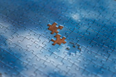 The missing piece of the sky puzzle, the concept of completing a big job, the final of the project, the successful solution of business problems. The hand puts the last piece of the jigsaw puzzle #638095858