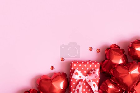 Photo for Gift box, candels and red heart shape baloons on pink background. Valentines Day concept. - Royalty Free Image