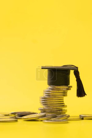 Photo for Graduated cap with coins and wallet fragment on yellow background. Savings for education concept. - Royalty Free Image