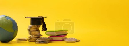 Photo for Banner with graduated cap with coins and globe on yellow background. Savings for education concept. - Royalty Free Image