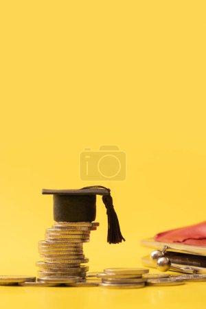 Photo for Graduated cap with coins on yellow background. Savings for education concept. Vertical photo. High quality photo - Royalty Free Image