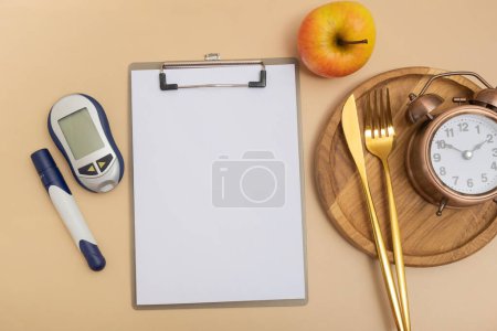 Photo for Empty text board and glucometer and cutlery with alarm clock on plate flat lay, top view. Mock up diabetes theme. - Royalty Free Image