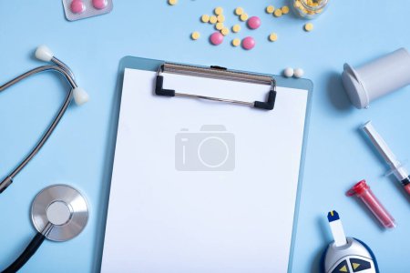 Photo for Blank tablet mockup with colorful pills, glucometer, syringe and stethoscope. Healthcare and medicine concept flat lay. - Royalty Free Image