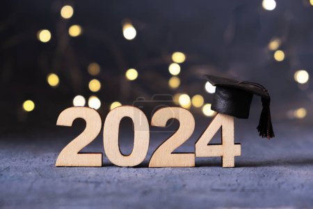 Class of 2024 concept. Number 2024 with graduated cap and bokeh lights-stock-photo