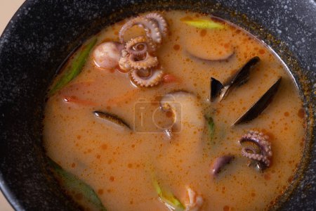 Photo for Close up Tom Yum soup with seafood top view. Octopuses and shells in soup - Royalty Free Image