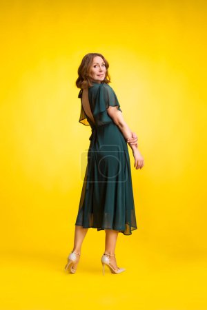 Photo for Stunning woman in elegant long dress in studio. Classy woman. - Royalty Free Image