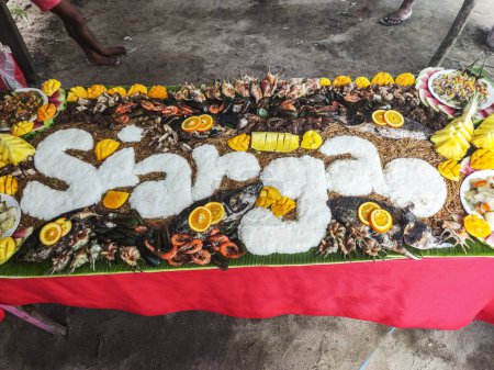 Siargao's boodle fight showcases the island's fresh seafood. Locals and visitors gather to share a bountiful spread of grilled, fried, and steamed fish and crustaceans, eating with their hands and celebrating the community's maritime traditions.