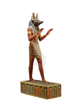 Photo for Ancient Egyptian statuette of god Anubis isolated on white background. Anubis is the god of funerary rites, protector of graves, and guide to the underworld, usually depicted as a canine or a man with a canine head - Royalty Free Image
