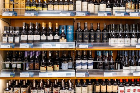 Foto de Helsinki, Finlandia - 09 agosto, 2022: Primer plano de las botellas de vino alineadas en un estante en una tienda, alcohol a la venta en una licorería - Imagen libre de derechos