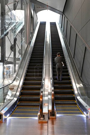 Photo for Auckland, New Zealand - August 02, 2022; Concept - Man Going Up In The World. On the Escalator of Life. - Royalty Free Image