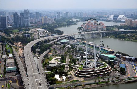 Photo for Singapore - July 27.2023; Singapore Flyer Observation Wheel amd motorways Aerial View. - Royalty Free Image