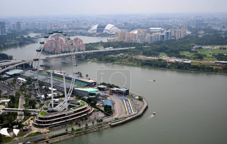 Photo for Singapore - July 27.2023; Singapore Flyer Observation Wheel amd motorways Aerial View. - Royalty Free Image