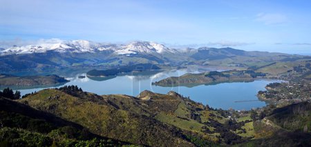 Photo for Lyttelton Harbour Winter Panorama with Snow on Mount Herbert reflected in the harbour and Governors Bay in the foreground, Christchurch, New Zealand - Royalty Free Image