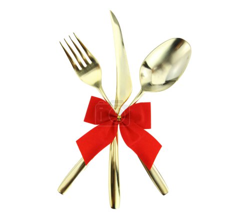 Photo for Christmas and Valentines table. Gold cutlery tied with red ribbon bow isolated on white - Royalty Free Image