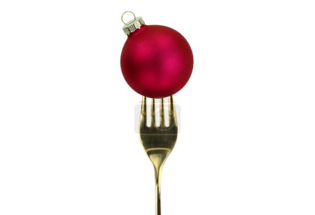 Photo for Christmas festive table. Gold fork and red Xmas bauble isolated on white - Royalty Free Image