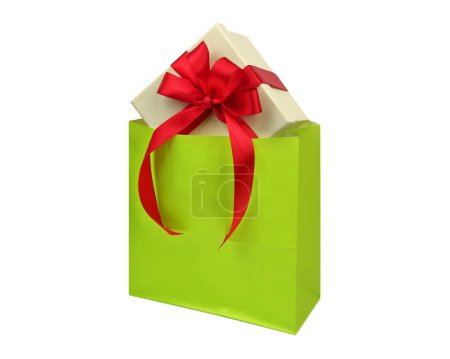 Photo for Christmas gift box red ribbon in a shopping bag isolated, white background. - Royalty Free Image