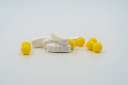Photo for Yellow vitamin capsules, Medicinal pills, tablets, pharmaceutical healthcare products, drugs for medical treatment, therapeutic medication, dietary supplements, pharmacological, health aid - Royalty Free Image