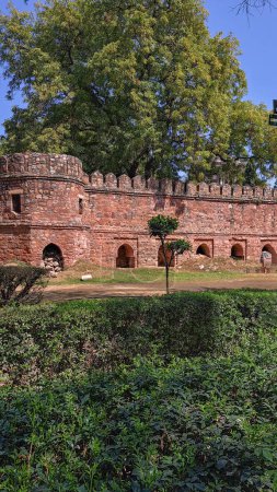 Ancient fortress wall near mausoleum Sikandar Lodi Tomb, Delhi. Intact battlements, arched recesses, bastion. Historical monument, citadel, ramparts. Mughal Empire. Indo-Islamic architecture, Defenses